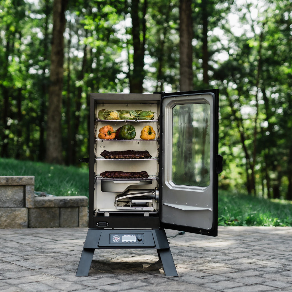 An open smoker sitting outside on a brick patio. The smoker is open to display 4 racks of food and the removable water bowl.