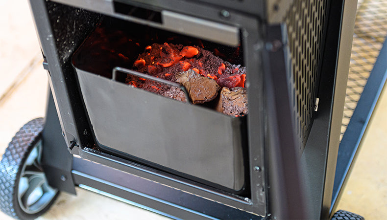 Charcoal burning in the bottom hopper of a Gravity Series Grill & Smoker