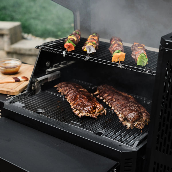 Gravity Series 600 grill with ribs and skewers cooking in it.