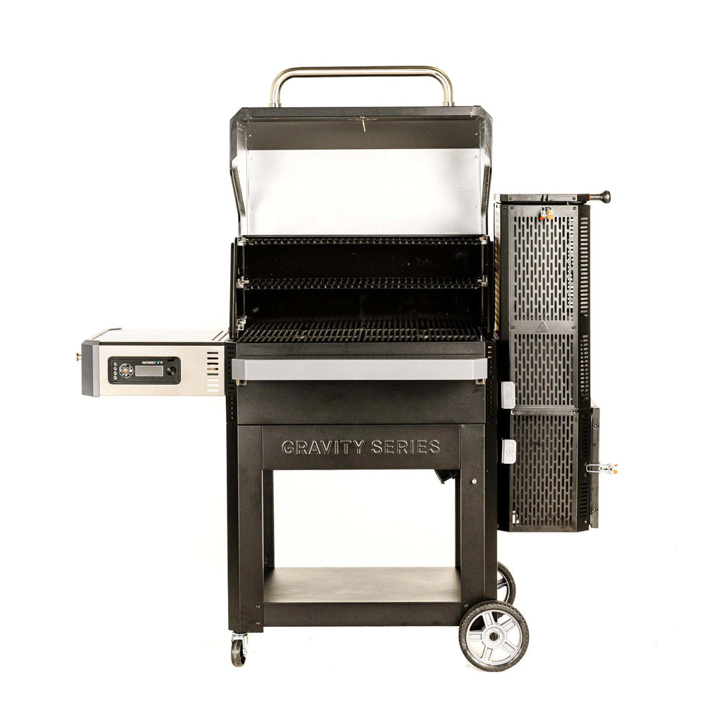 Open Gravity Series 1050 showing large main cooking space with 2 warming racks above it. Grill sits on a cart with 4 wheels (2 large on right, 2 small on left).