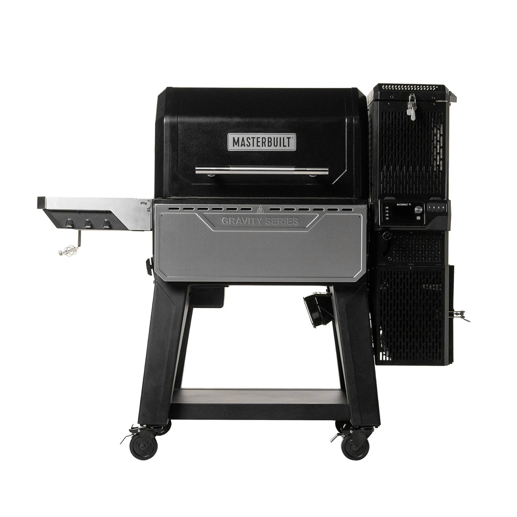 Gravity Series XT. Black grill with side shelf on left, charcoal hopper on right, and folding stainless steel shelf across the front. Grill is on cart with 4 wheels.