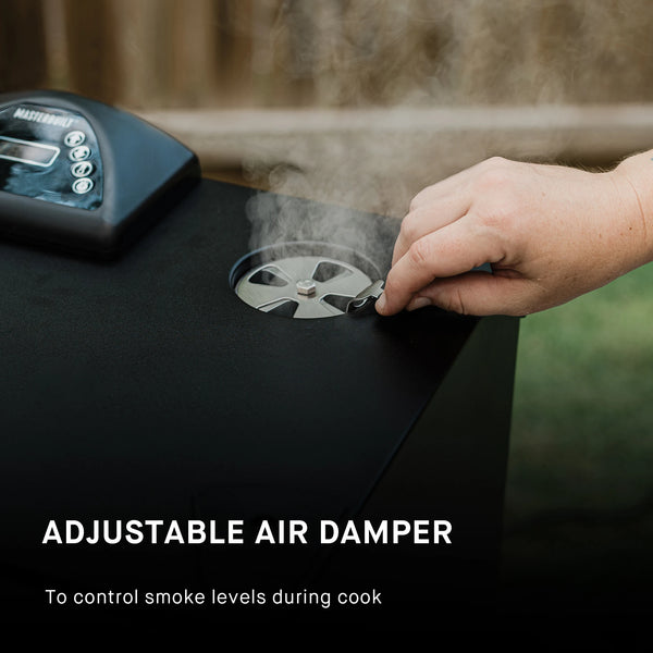 A close-up of a hand adjusting a metal damper on the lid of a black grill, with visible steam or smoke rising. Text on the image reads 'ADJUSTABLE AIR DAMPER To control smoke levels during cook.'