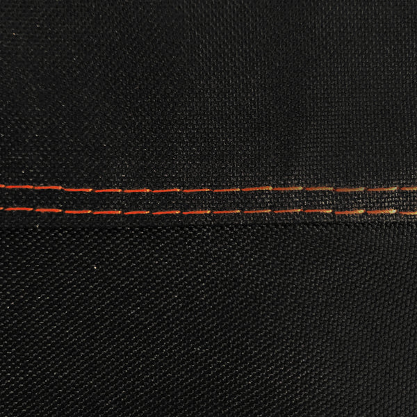Closeup of the double-stitching on the cover. The stitching is done in orange to make a visual highlight against the black cover.