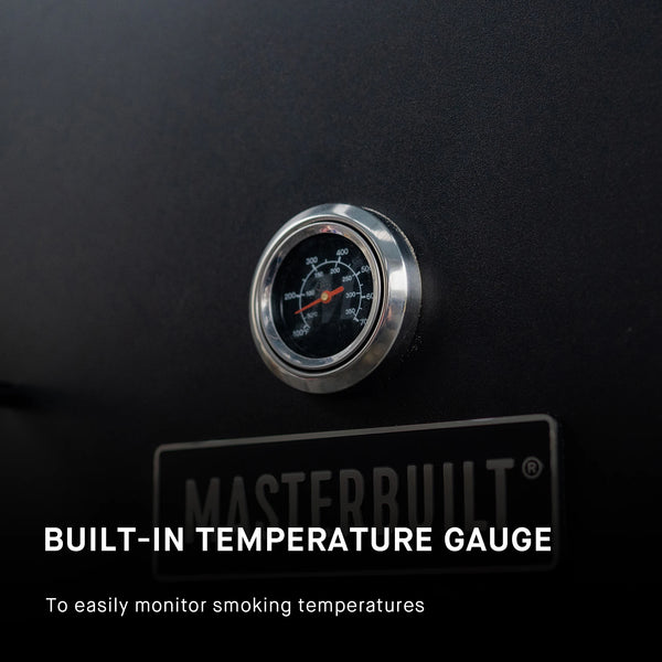 Closeup of the built-in temperature gauge mounted on the door just above the Masterbuilt logo plate.  Text reads: build-in temperature gauge to easily monitor smoking temperatures.