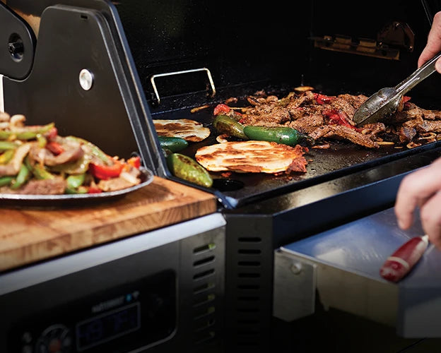 Cooking fajitas on the griddle of a Gravity Series 800 grill. 