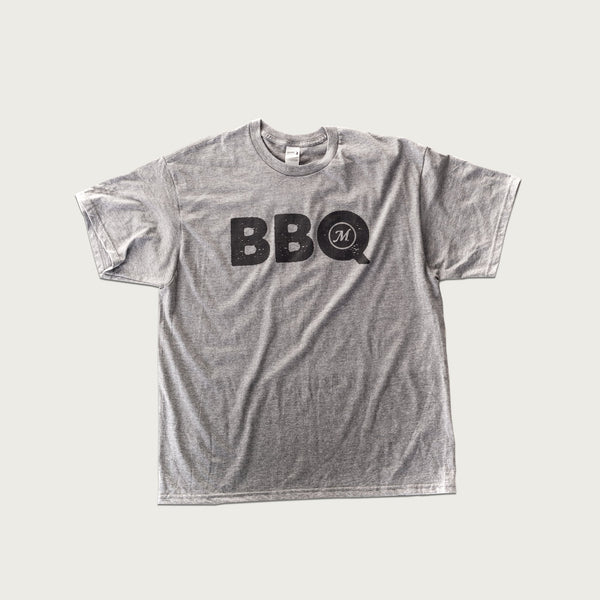 Gray t-shirt with BBQ in black on the front. The Q encloses the Masterbuilt logo.