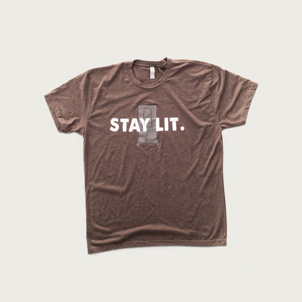 Light brown short-sleeved t-shirt with the silhouette of a smoker in gray and the words Stay Lit printed across it in white  centered on the front